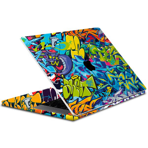 A MacBook Pro 14-inch skin with a colorful abstract pattern covering the top, bottom, keyboard, and trackpad.